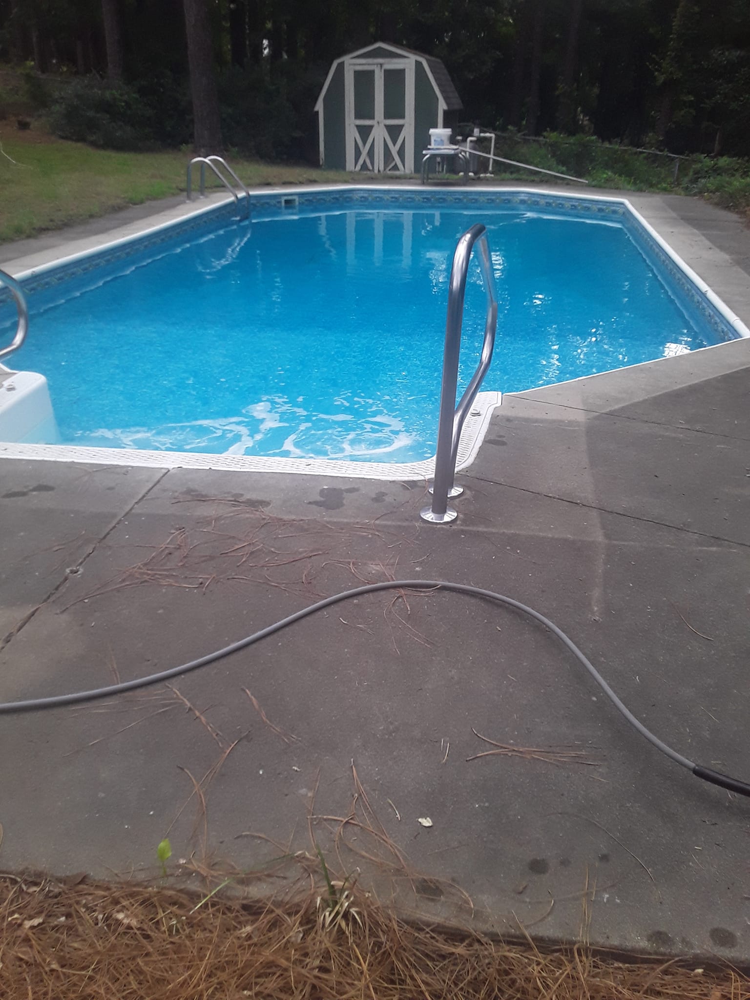 Dirty pool area before pressure washing